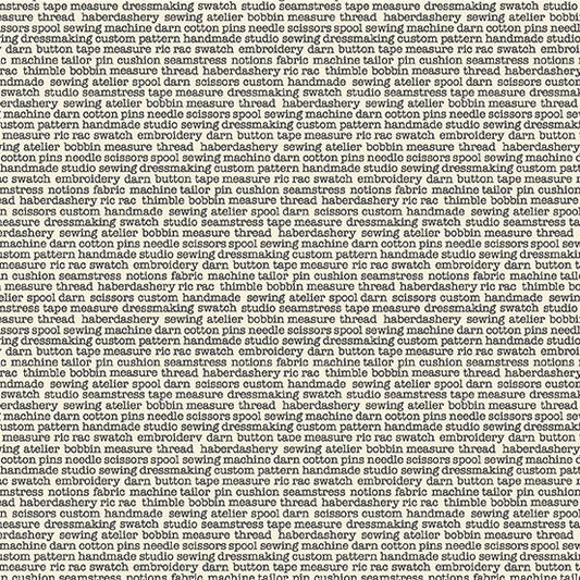 fabric with sewing themed words in typewriter font on cream background