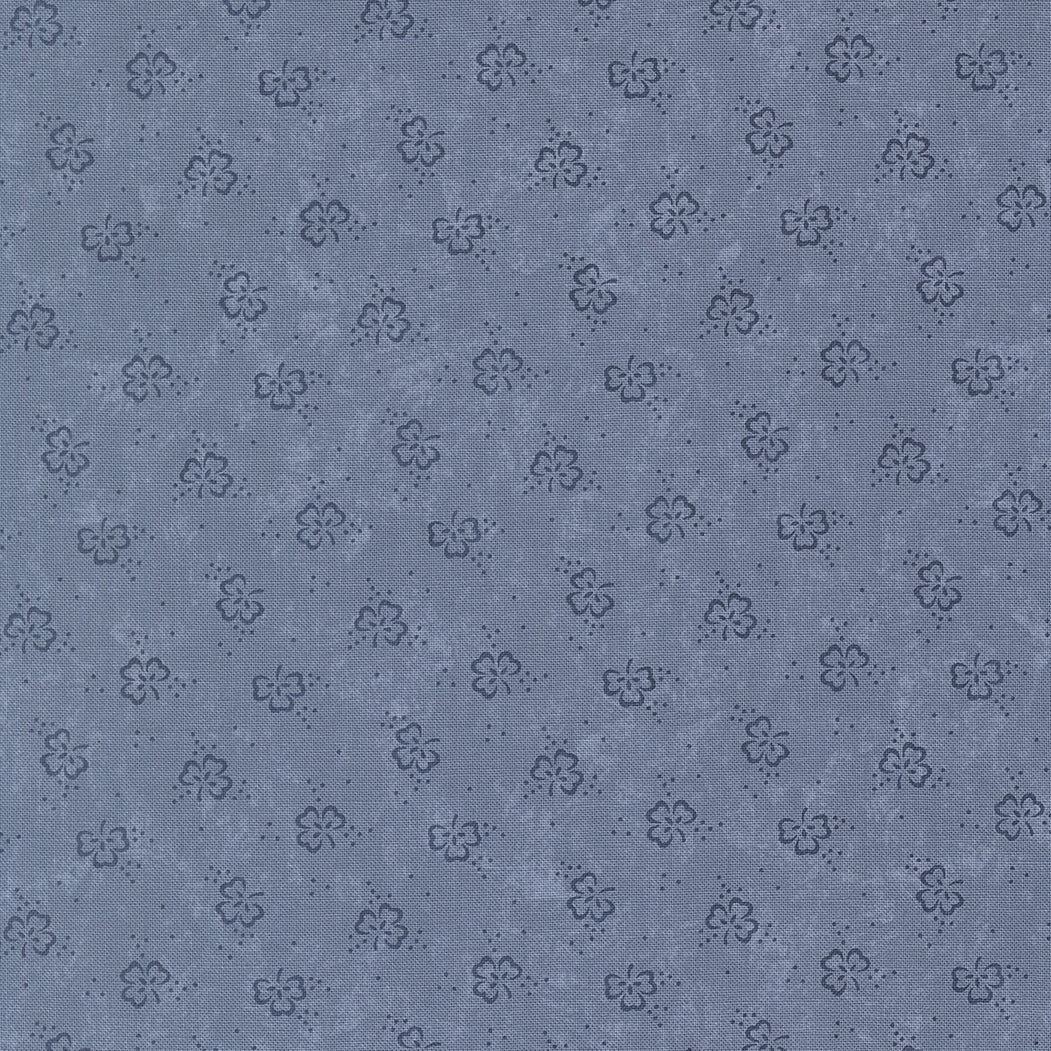 Patterned fabric texture with small floral designs on a blue background