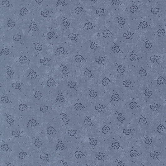 Patterned fabric texture with small floral designs on a blue background