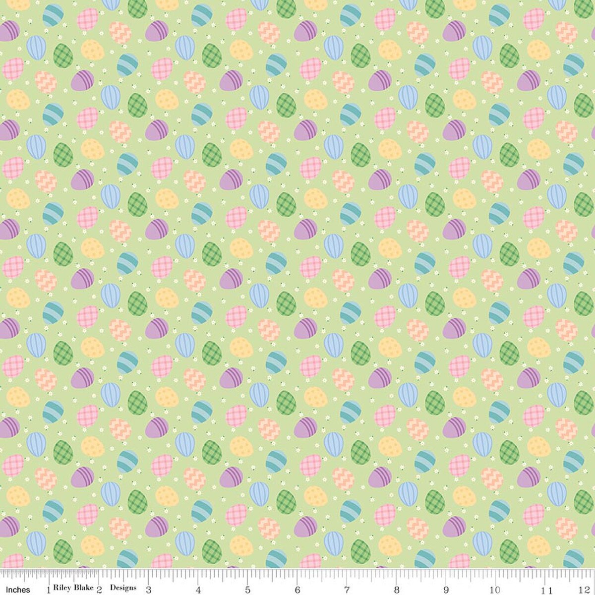 Patterned fabric with Easter eggs and flowers on a green background