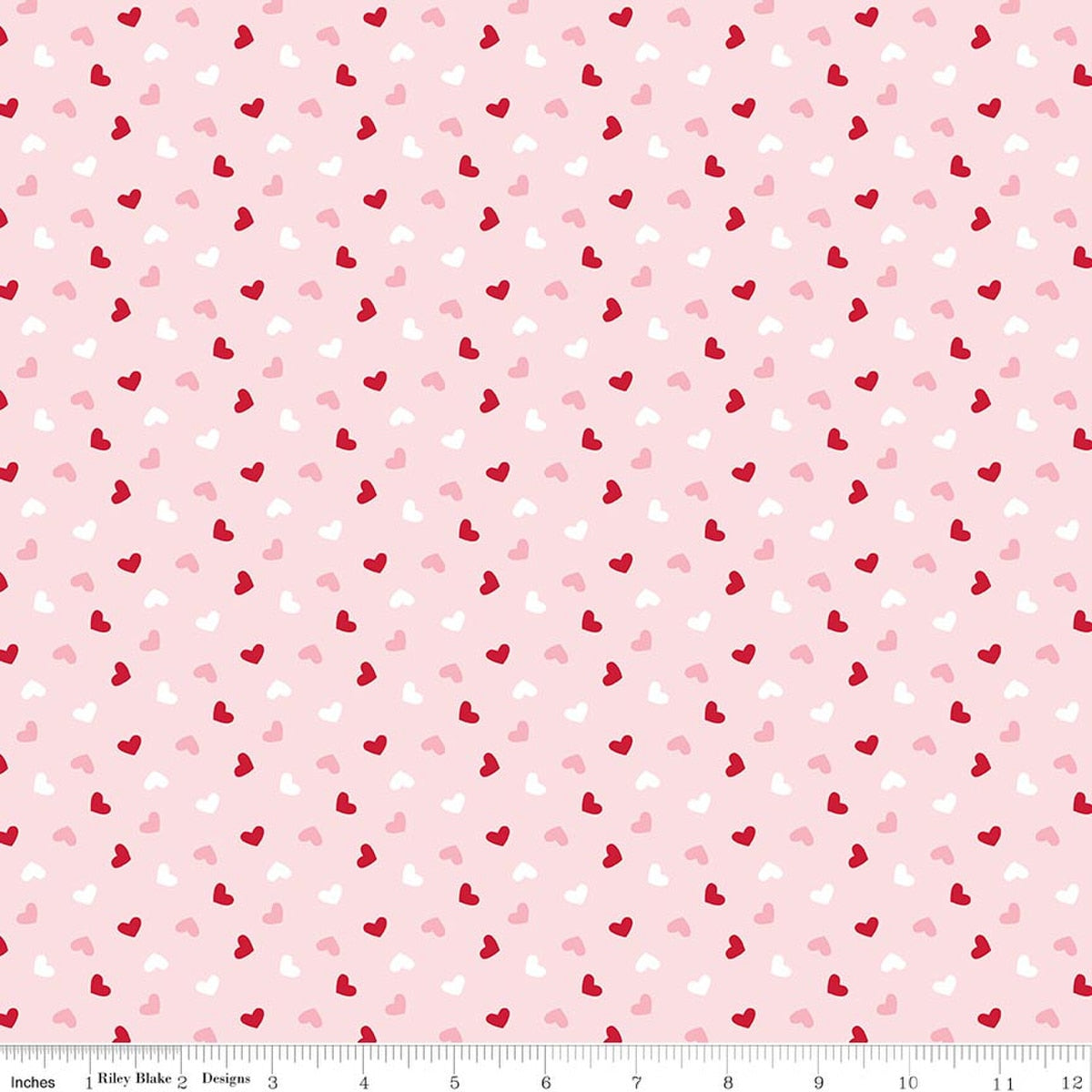 Pattern of small red and pink hearts on a light pink background with a ruler at the bottom.